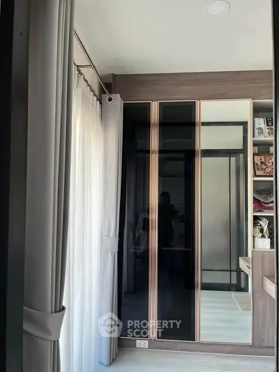 Modern bedroom with sleek wardrobe and natural light