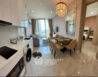 Luxurious open-plan living room with elegant dining area and modern kitchen in high-rise apartment.