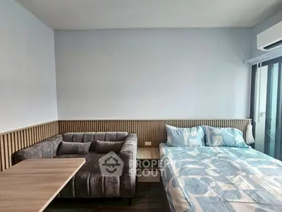 Modern bedroom with stylish sofa and cozy bed in bright apartment
