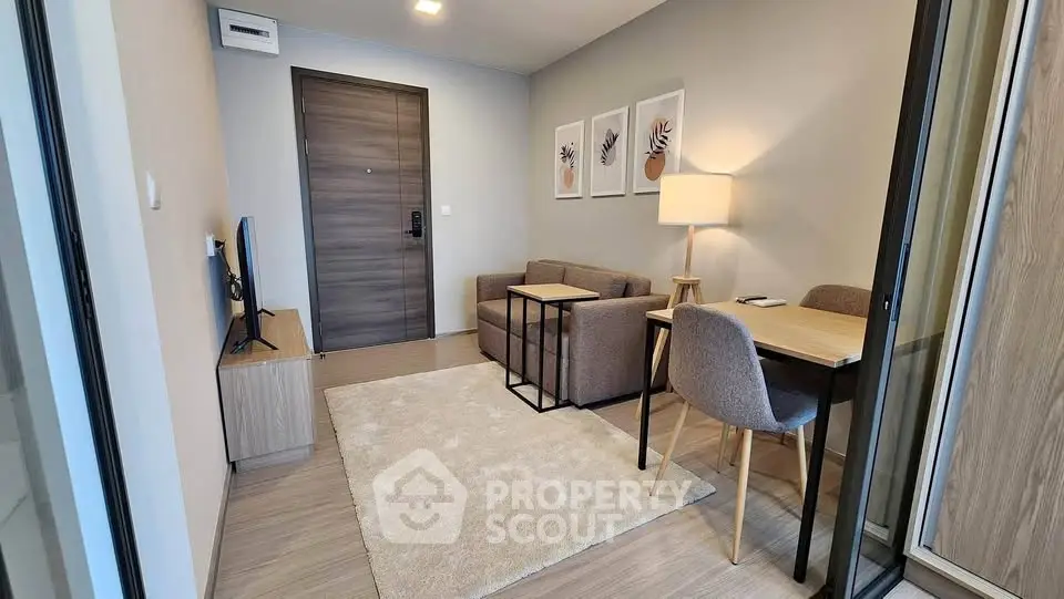 Modern living room with cozy seating and stylish decor in a contemporary apartment.