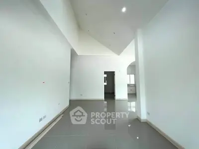 Spacious modern living room with high ceilings and sleek tile flooring