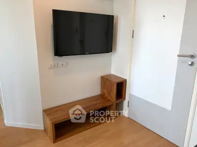 Modern living room corner with mounted TV and wooden bench