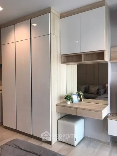 Modern bedroom with sleek wardrobe and stylish vanity area