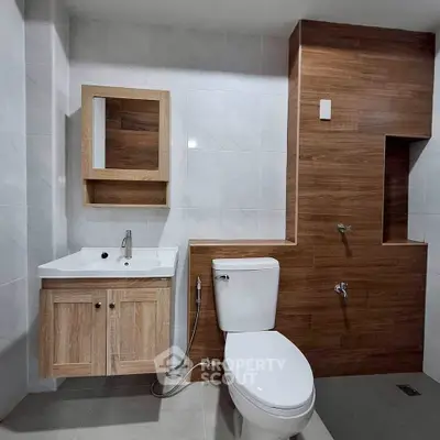 Modern bathroom with sleek wooden accents and contemporary fixtures