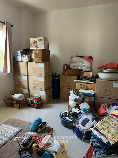 Spacious storage room filled with boxes and household items, ideal for organizing and decluttering.