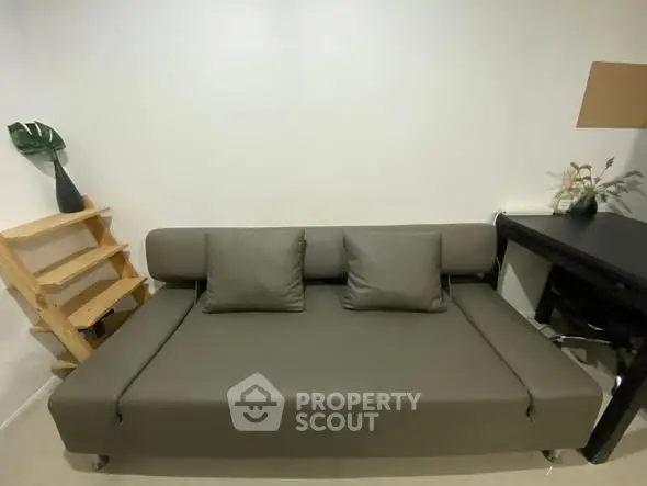 Modern minimalist living room with sleek gray sofa and stylish decor