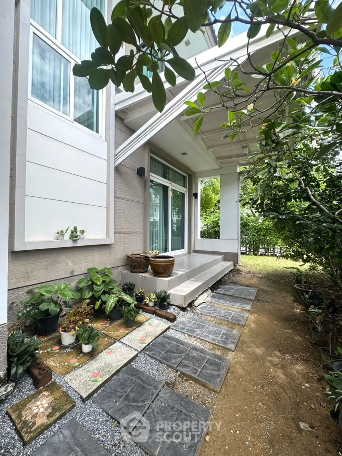 Charming garden entrance with lush greenery and modern architectural design