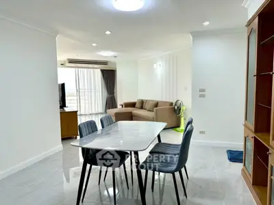 Spacious living room with modern dining area and natural light