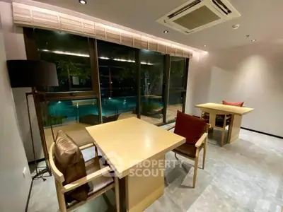 Modern interior with pool view, featuring stylish furniture and ambient lighting for a luxurious ambiance.