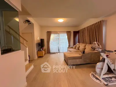 Spacious living room with modern decor and exercise bike
