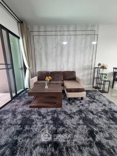 Modern living room with plush carpet and stylish furniture