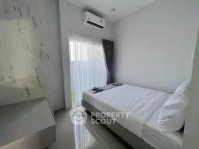 Modern minimalist bedroom with sleek design and natural light