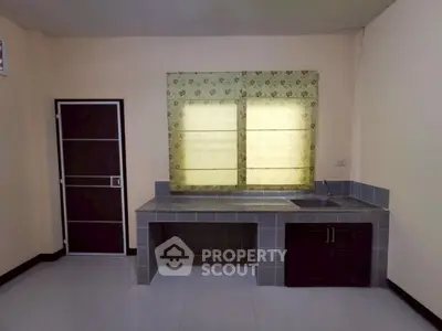 Minimalist kitchen with closed layout and tiled countertops