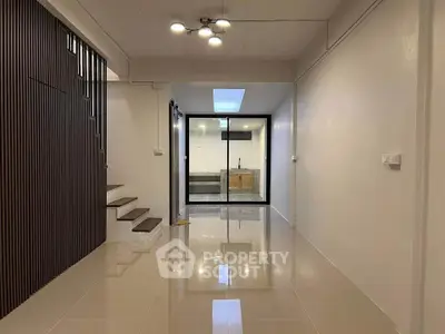 Modern interior with sleek staircase and open kitchen layout