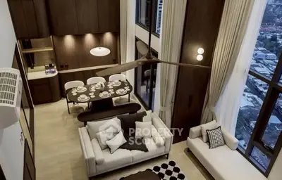 Luxurious double-height living room with elegant dining area and stunning city view.