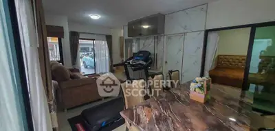 Spacious living room with treadmill and marble dining table, perfect for modern lifestyle.