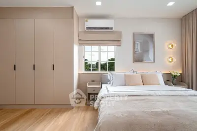 Modern bedroom with elegant decor, large window, and stylish lighting.