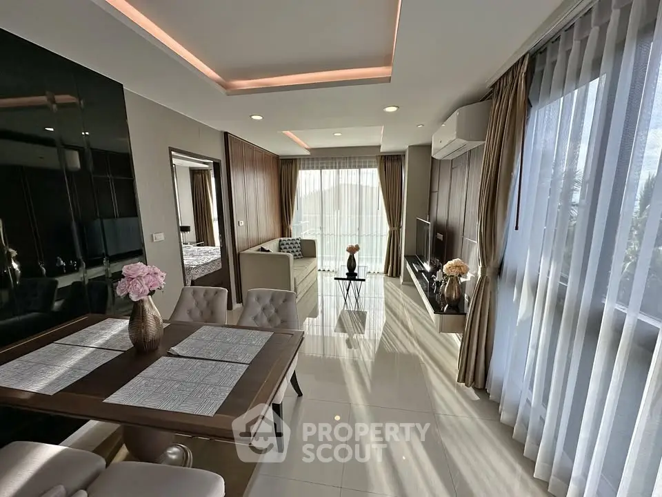 Modern open-plan living and dining area with elegant decor and natural light