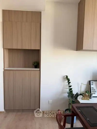 Modern interior with wooden cabinetry and stylish decor in a cozy living space.