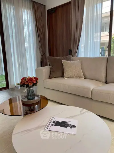 Elegant living room with modern sofa and stylish coffee table, perfect for relaxation.