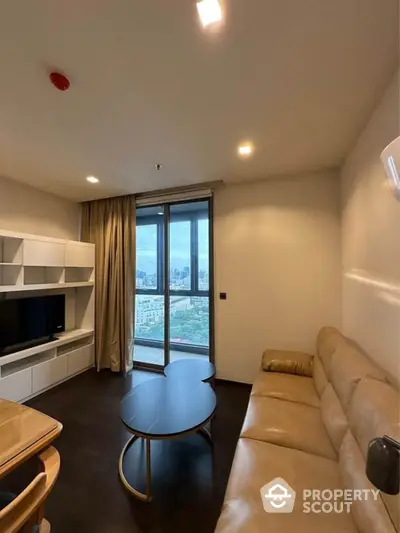 Modern living room with city view, sleek furniture, and large windows in a high-rise apartment.