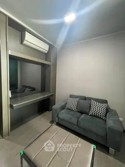 Cozy living room with modern sofa and air conditioning unit