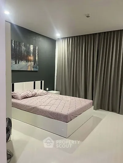 Modern bedroom with sleek design, featuring a comfortable bed and elegant curtains, perfect for relaxation.