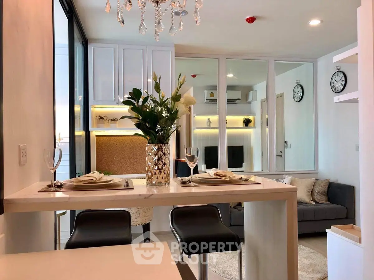 Modern living room with elegant decor and open layout, featuring a stylish dining area and cozy seating.