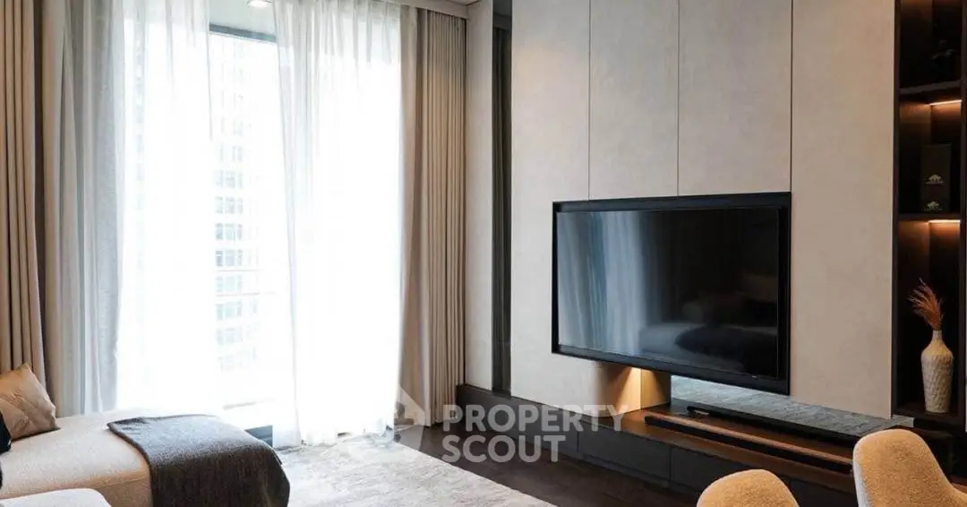 Luxurious living room with modern decor and large flat-screen TV, perfect for relaxation.