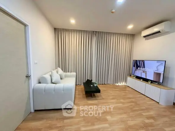 Modern living room with sleek furniture and air conditioning, perfect for comfortable living.