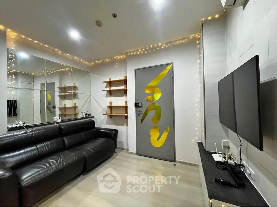 Modern living room with sleek black leather sofa and stylish decor