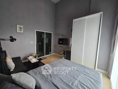 Modern bedroom with stylish decor and ample natural light