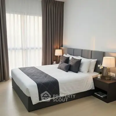 Elegant bedroom with modern decor and natural light from large window.