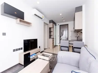 Modern living room with sleek furniture and open kitchen layout