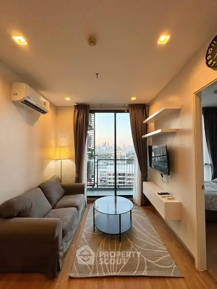 Modern living room with city view, cozy sofa, and stylish decor.