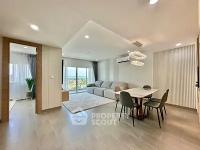 Spacious modern living room with dining area and large windows offering stunning views.