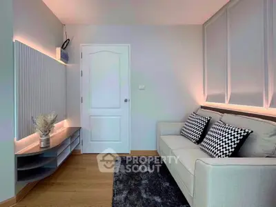 Modern living room with stylish sofa and decorative wall panels, perfect for cozy relaxation.