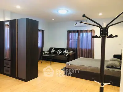 Spacious modern bedroom with stylish furniture and natural light