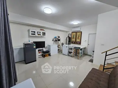 Spacious living room with modern decor and ample natural light, perfect for relaxation and entertainment.