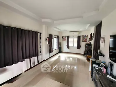 Spacious living room with modern decor and large windows for natural light