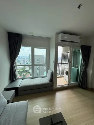 Modern living room with city view and balcony featuring washing machine.