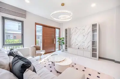 Luxurious modern living room with elegant chandelier and marble accent wall