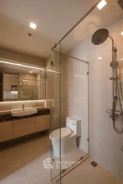 Modern bathroom with glass shower enclosure and sleek fixtures