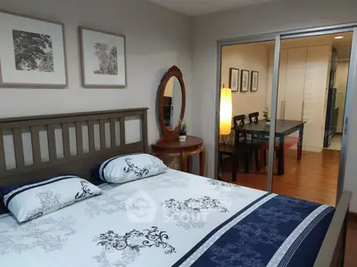 Cozy bedroom with elegant decor and adjacent dining area in modern apartment