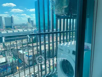 High-rise balcony with washing machine and stunning cityscape view