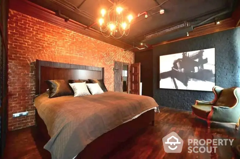 Luxurious industrial-style bedroom with exposed brick walls and elegant lighting