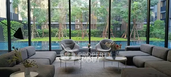 Luxurious living room with pool view and modern furniture in upscale residence.