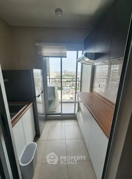 Modern kitchen with balcony view and sleek cabinetry