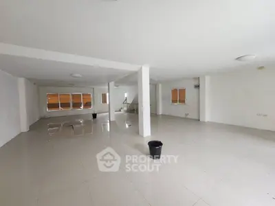 Spacious open-plan interior with tiled flooring and ample natural light, ideal for versatile use.