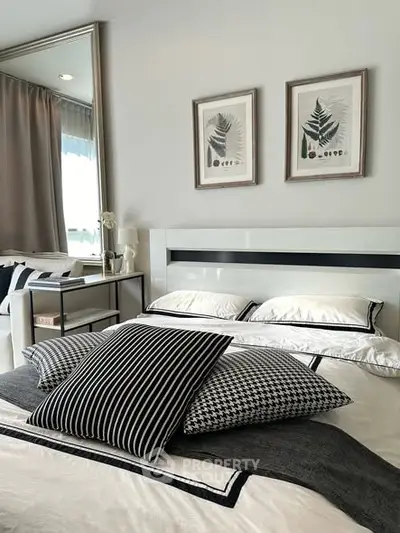 Stylish bedroom with modern decor and elegant framed artwork